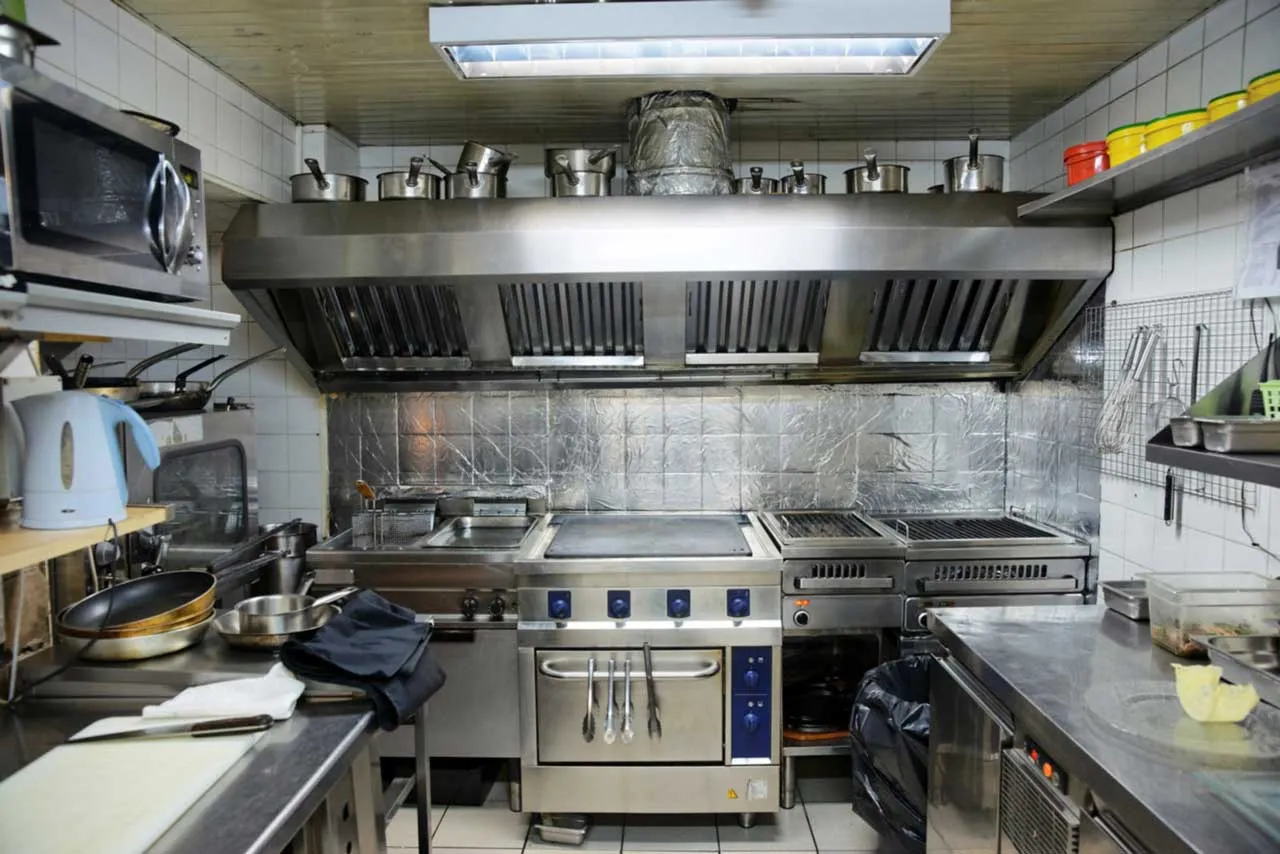 Professional hood cleaning technician servicing a restaurant exhaust system in San Bernardino